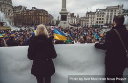 London, England, United Kingdom - March 5 2022: Two people holding banner looking out at protest 4AOMm0