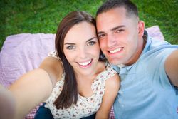 Happy Young Couple Shooting Selfie in the Park.