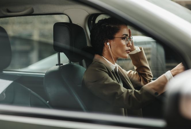 Woman in formalwear driving to work