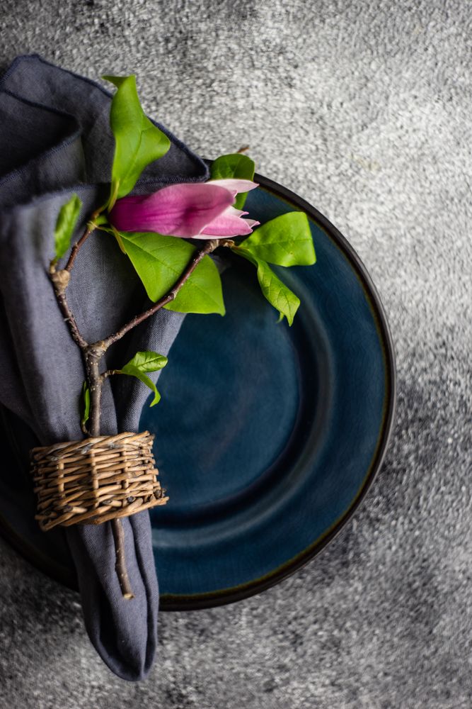 Top view of navy plate with magnolia branch