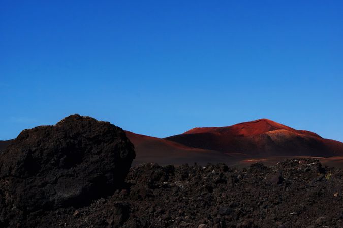 Picturesque view of volcanic terrain with solidified lava in wild area