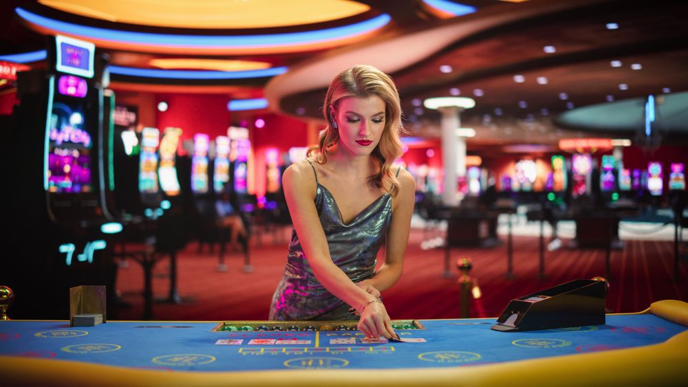 Portrait of a Female Croupier Looking at the Camera and Sharing the Results of a Baccarat Card Game.