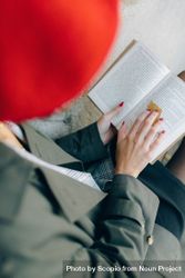 Top view of woman with red hat reading a book 5QY9g5