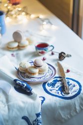 Christmas macarons served with tea on festive table