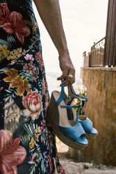 Crop woman holding summer wedge heels
