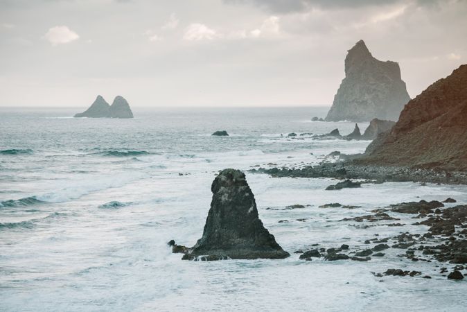 Lonely cliff in sea on cloudy day