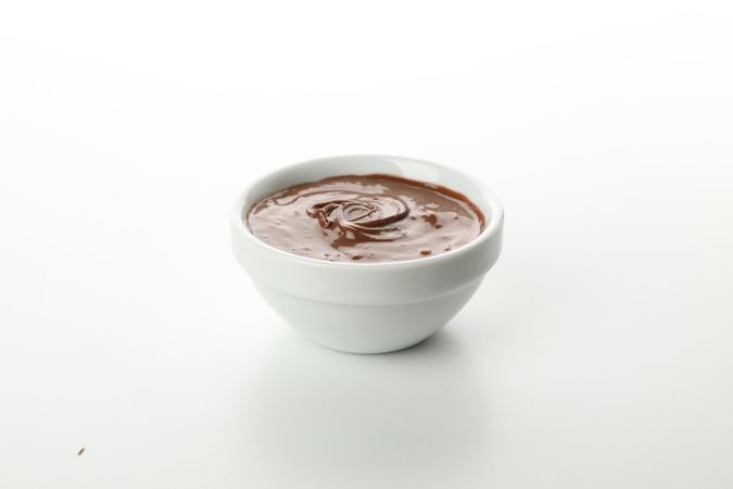 Bowl with melted chocolate isolated on plain background