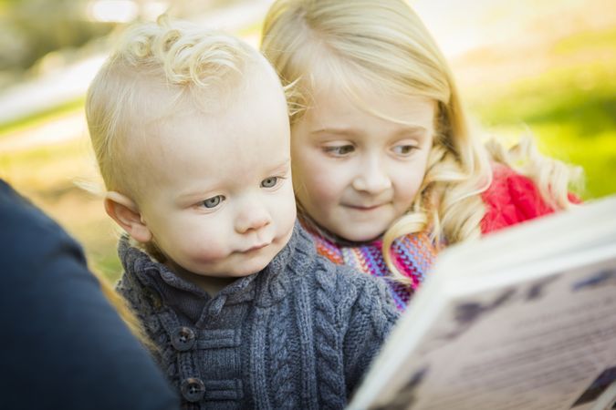Mother Reading a Book to Her Two Adorable Blonde Children.