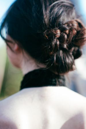 Close up shot of woman’s hair bun and her back