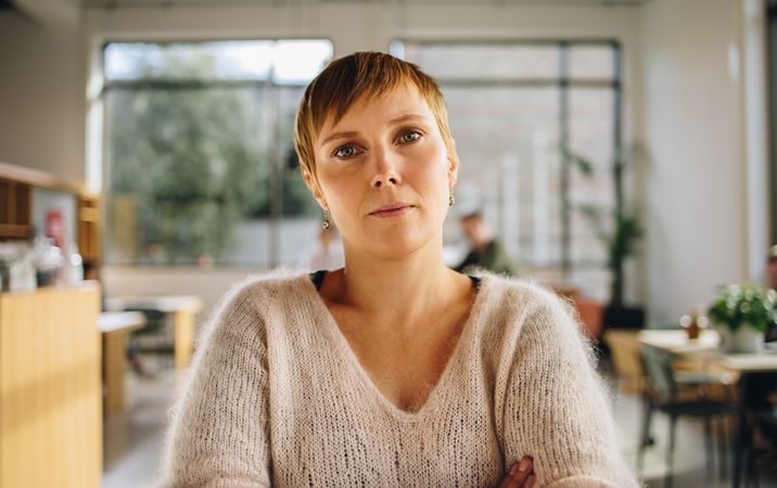 Young woman standing in coworking office
