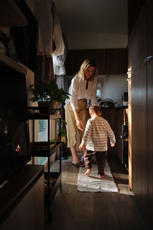 Woman and boy playing in kitchen