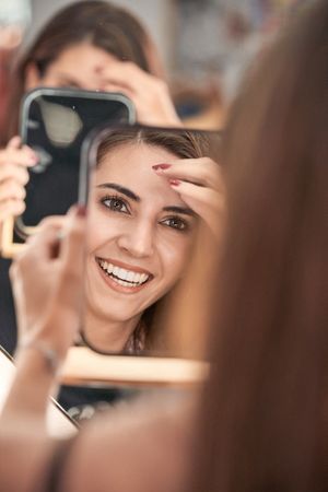 Delighted model looking at mirror