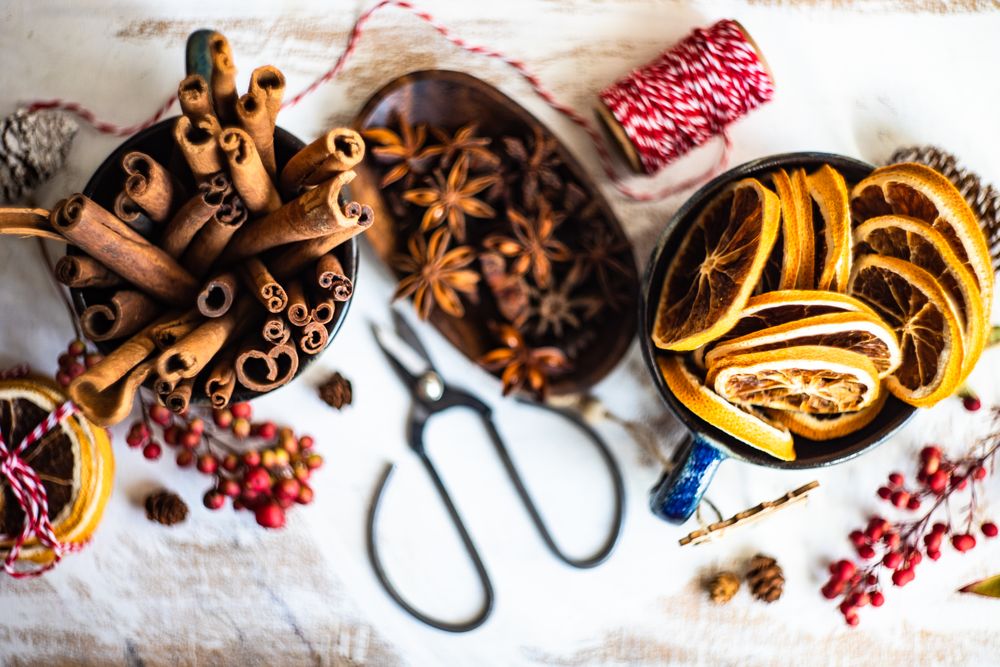 Top view of dried orange slices and anise star and cinnamon sticks on table