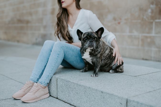 Woman with cute bulldog on street