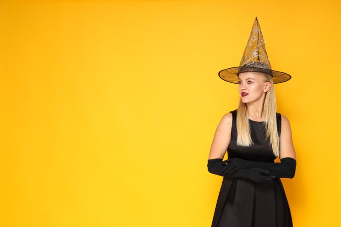 A woman in a Halloween costume on a yellow background