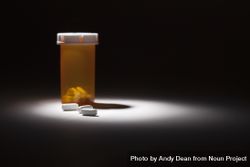 Medicine Bottle and Pills Under Spot Light beXGe6