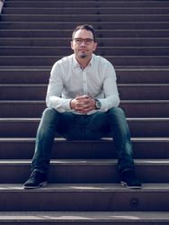 Content man sitting on stairs
