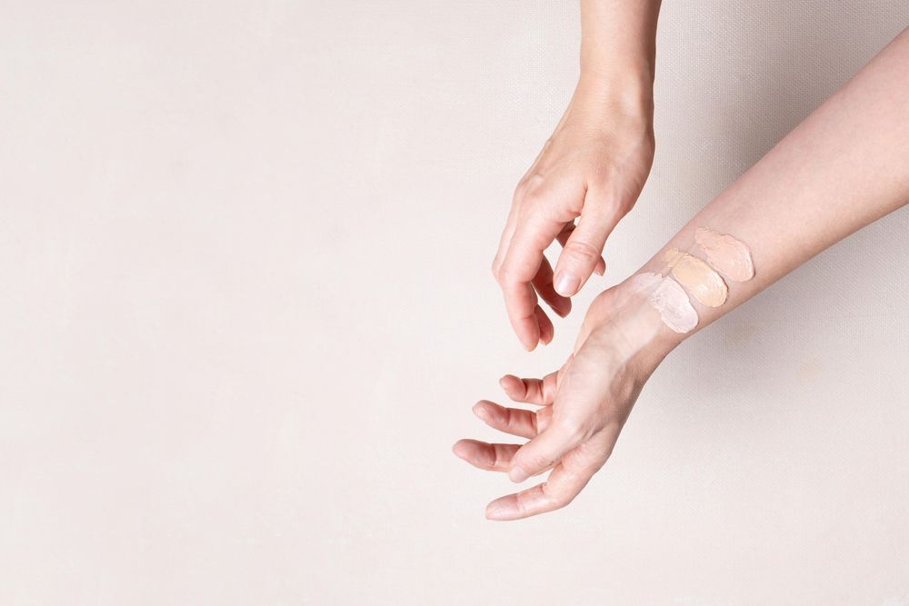 Woman testing foundation colors on wrist