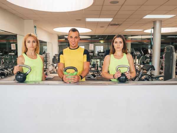 Athletes with kettlebells at the gym