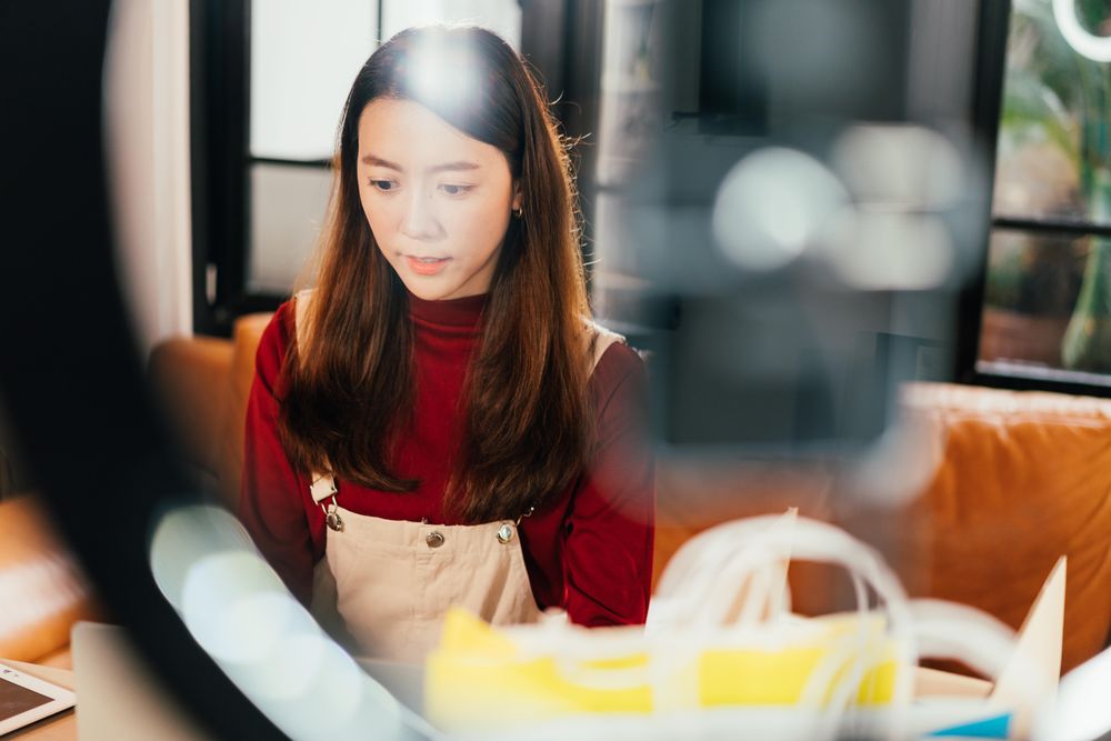 Asian woman working on her e-commerse business from home