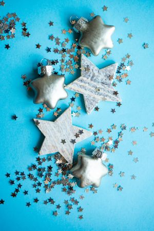 Festive xmas card concept of star baubles on blue background