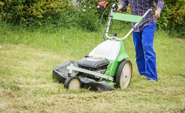 man mowing the lawn with a lawnmower