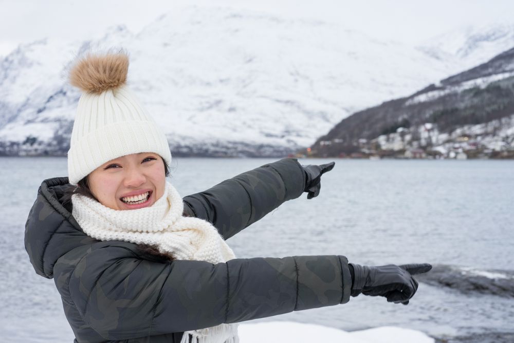 Joyful young woman in warm clothes