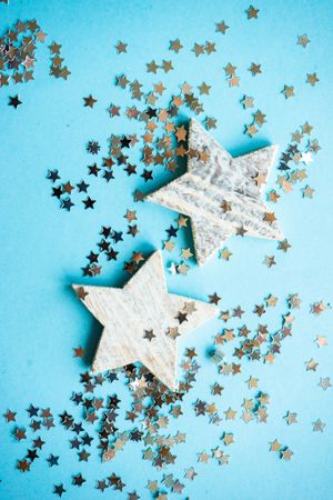 Festive xmas card concept of star ornaments on blue background