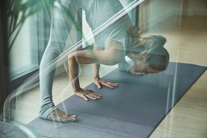 Adult female athlete doing yoga in Wide Legged Forward Bend pose