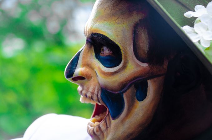 Person with sugar skull face paint opening their mouth