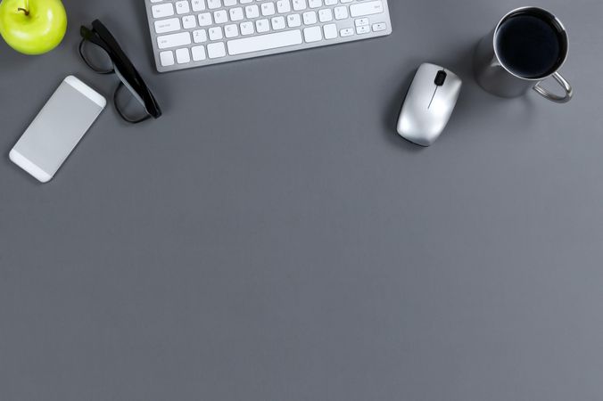 Gray Desktop with top border of technology with food and drink