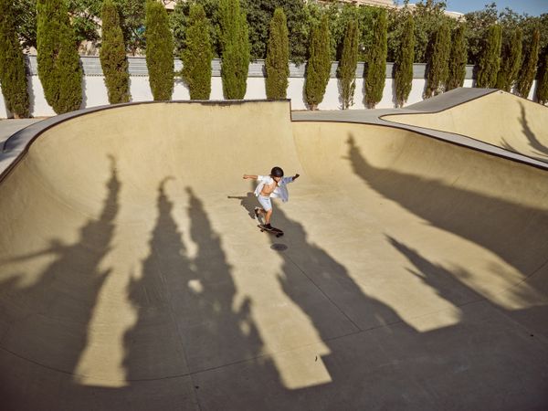 Boy riding longboard on sunny day
