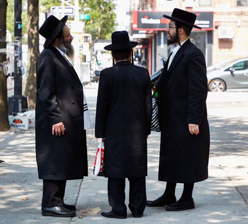 Three Hasidic Jews in a traditional long, dark jackets and hats, Brooklyn, New York
