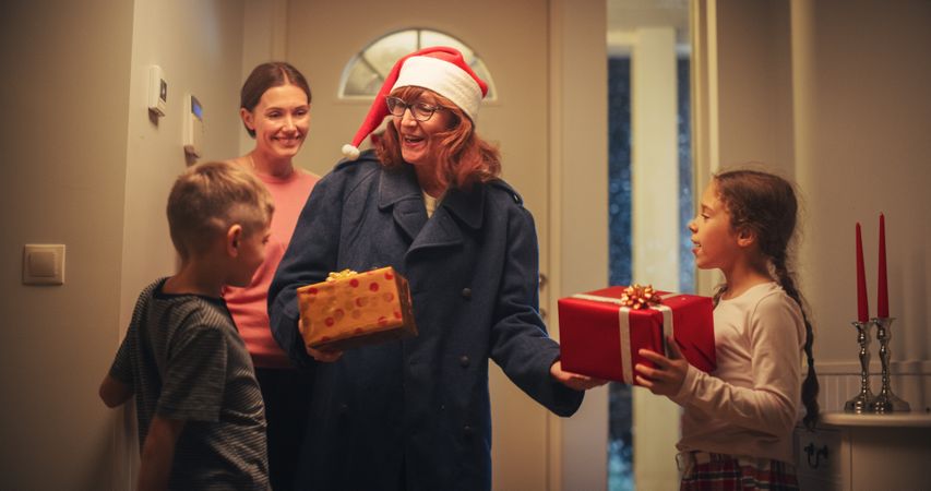 Grandmother Visiting Family for Christmas Holidays on a Snowy Winter Evening.