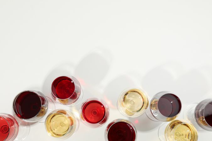 Flat lay composition. Glasses with different wine on blank background, top view