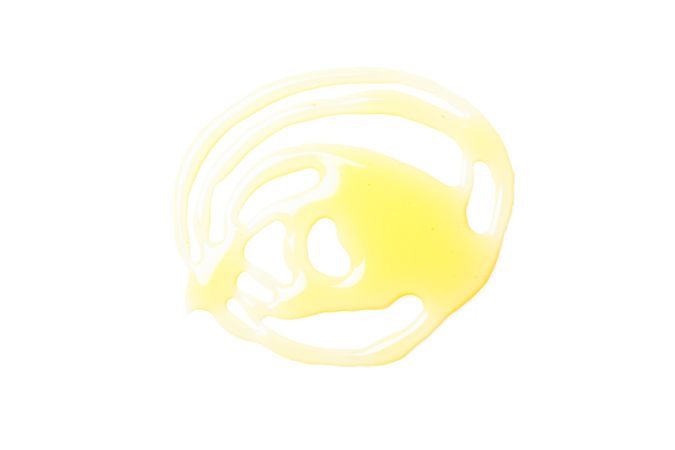 Sweet honey smear isolated on neutral background