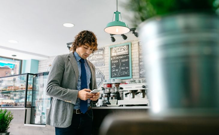 Businessman looking mobile in a cafe