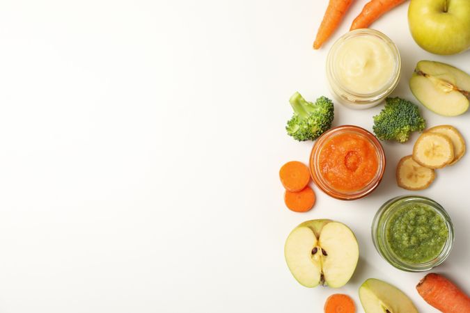 Composition with baby food on plain background, top view