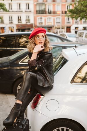 Cheerful female tourist near car