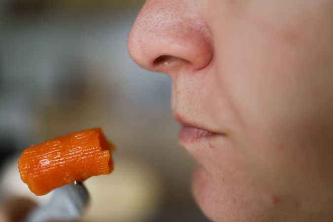Organic Carrot Crunch: Woman Embracing Healthy Eating with a Fresh, Nutritious Snack.