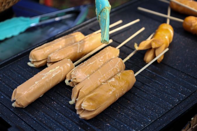 Sosis Bakar, Smearing Margarine to the Raw Sausage on the Grill