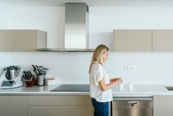 Woman making tea in kitchen