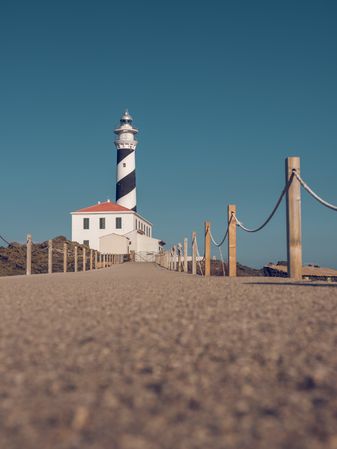 Sidewalk leading to lighthouse in countryside