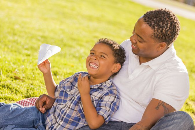 Father and Son Playing with Paper Airplanes