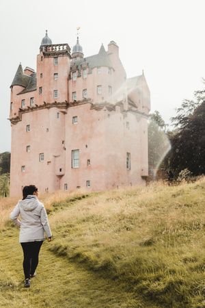 Woman standing next to medieval castle