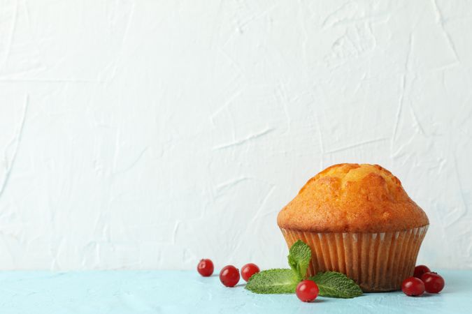 Delicious muffin and berries on blank background. Sweet food