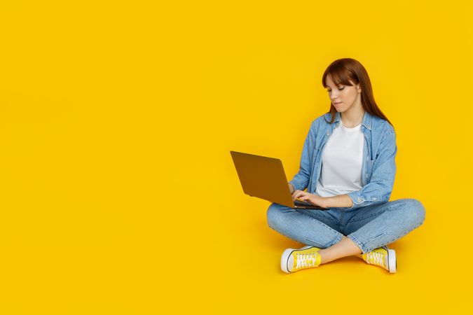 Concept of people, young woman on yellow background