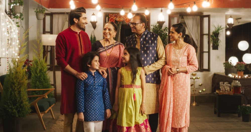 Portrait of Happy Indian Family in Traditional Clothes Laughing and Posing Together in Authentic Mumbai House.