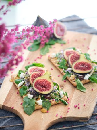 Decorated fig fruit slices on cutting board