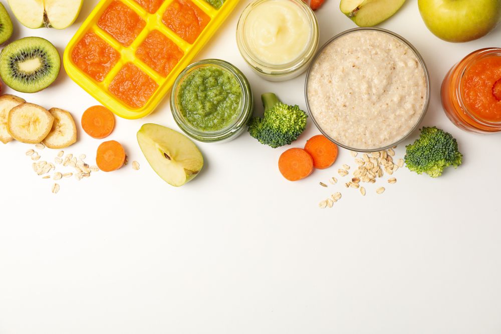 Composition with baby food on plain background, top view